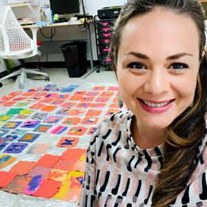 artist Maria Amalia Wood stands in front of handmade paper