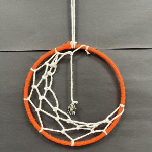 orange and white macarame spider web