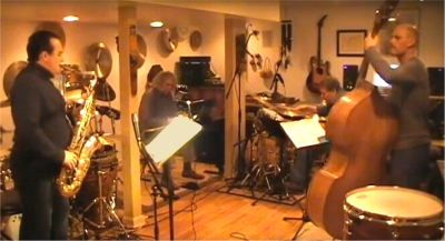 A screencap from YouTube of the Michael BB quartet playing in a studio