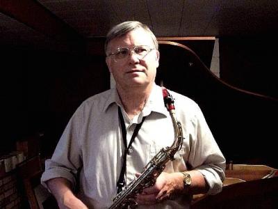 A picture of Ray Rideout holding his saxophone