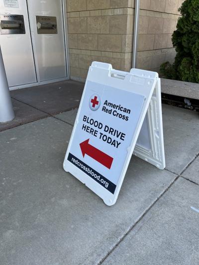 A sandwich board reading "Blood drive here today" sits outside Sequoya Library