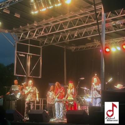 The band Mideast Salsa playing an outdoor venue at night.